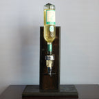 Bottle of white wine on a wooden stand against a gray background