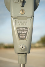 Close-up of a parking meter with 'Duncan Meter' branding on a blurred background.