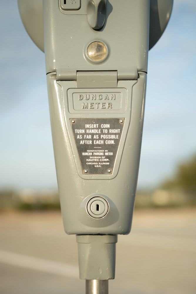 Close-up of a parking meter with 'Duncan Meter' branding on a blurred background.