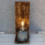 Wooden wall sconce with a vintage-style light bulb on a white surface.