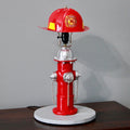 Red fire hydrant lamp with a fire helmet on top against a gray background