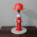 Red fire hydrant lamp with a fire helmet on top against a gray background