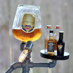 Glass of beer on a metal stand with small bottles of alcohol against a blurred background