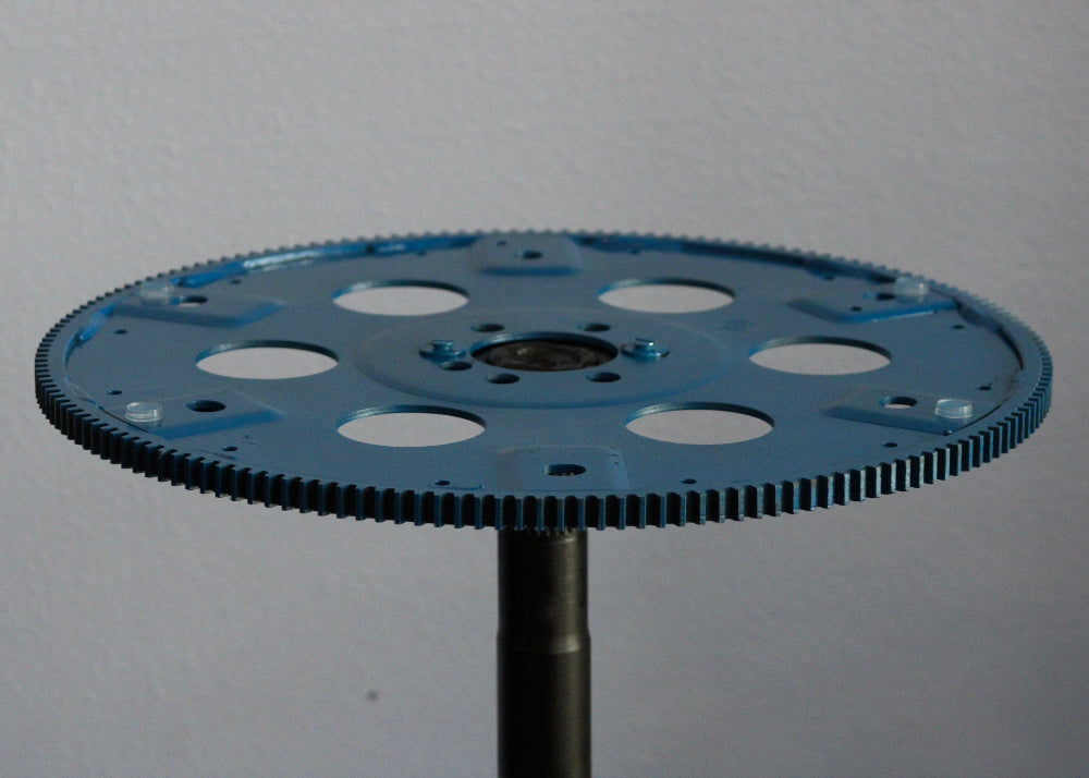 Blue gear wheel on a gray background