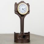 Decorative clock designed like a piston on a white background