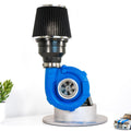 Turbocharger on a white background with a small car model and plant