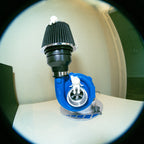 Close-up of a blue and black mechanical component on a white surface.