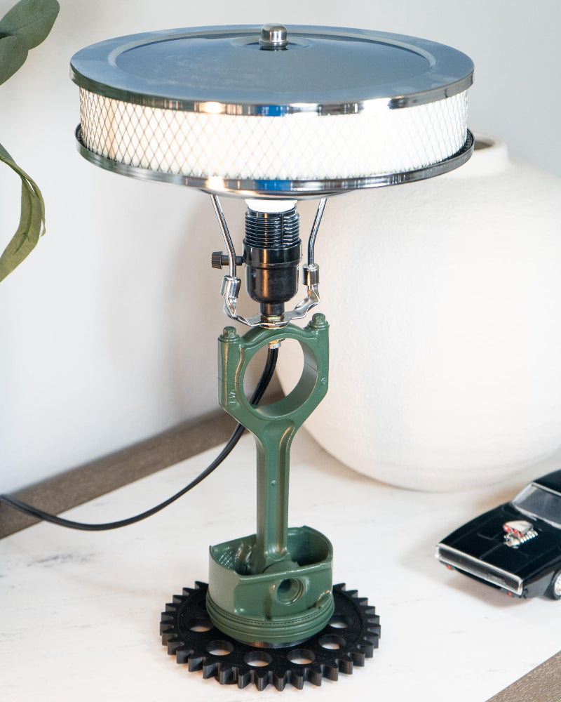 Vintage-style lamp with mechanical design on a white surface