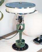 Vintage-style lamp with mechanical design on a white surface