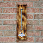 Wooden bottle opener with Grey Goose branding on a brick wall