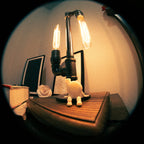 Vintage-style lamp with two lit bulbs on a wooden surface.