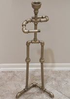 Decorative stand made of metal pipes against a plain wall.