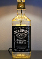 Jack Daniel's Tennessee Whiskey bottle lamp on a reflective surface with a neutral background
