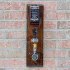 Jack Daniel's bottle mounted on a wooden plaque against a brick wall