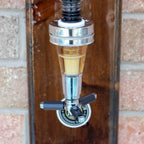 Metallic faucet with a wooden handle against a brick wall background