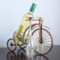 Wine bottle on a decorative bicycle stand with a plain background