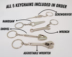 Set of five keychains with tool designs on a white background