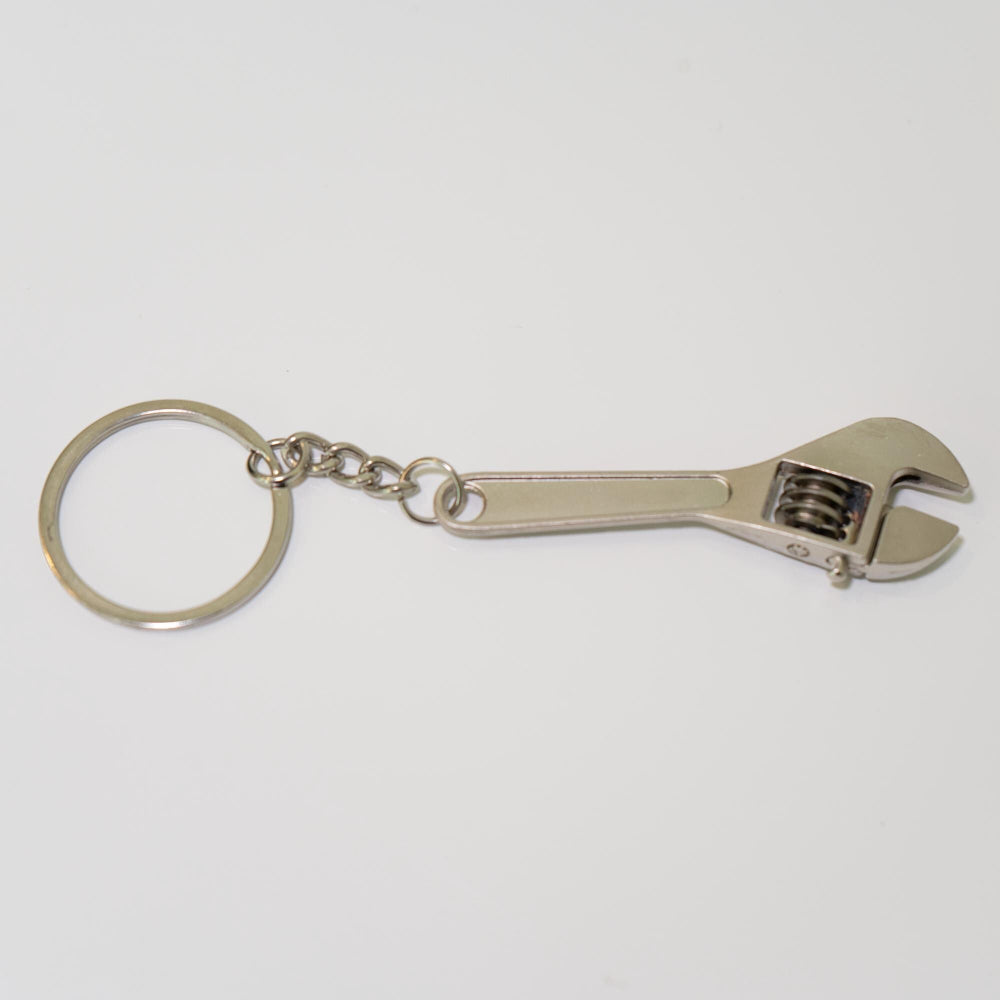 Metal wrench keychain on a white background