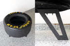 GoodYear tire and a black metal stand on a textured surface