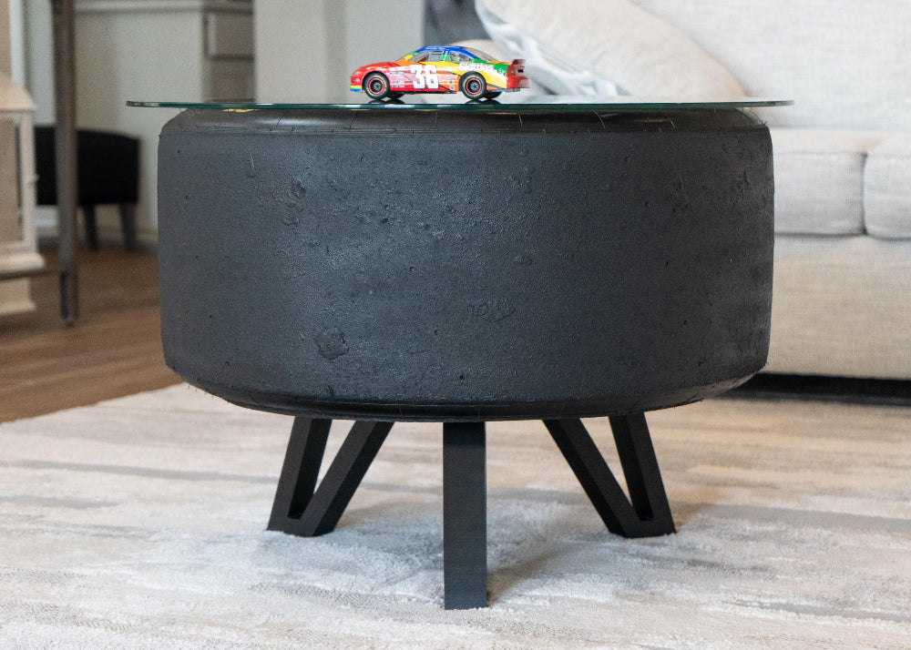 Black concrete coffee table with a glass top in a living room setting