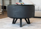 Black concrete coffee table with a glass top in a living room setting