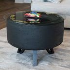 Black coffee table with a glass top displaying a colorful toy car in a living room setting.