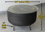 Black fire pit with measurements labeled on a concrete surface