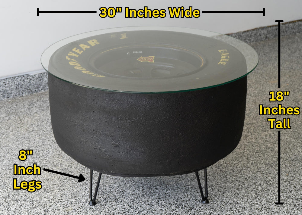 Black fire pit with measurements labeled on a concrete surface