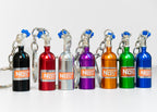 Set of colorful NOS bottle keychains on a white background