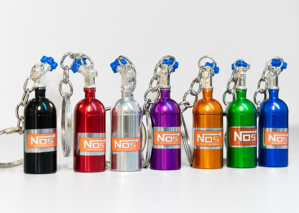 Set of colorful NOS bottle keychains on a white background