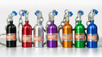 Set of colorful NOS (Nitrous Oxide Systems) canisters on a white background