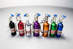 Set of colorful NOS bottle keychains on a gray background