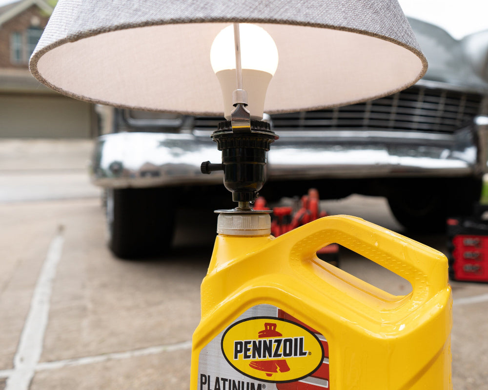 Lamp made from a Pennzoil oil can with a classic car in the background
