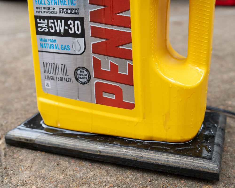 Yellow Pennzoil oil container on a concrete surface