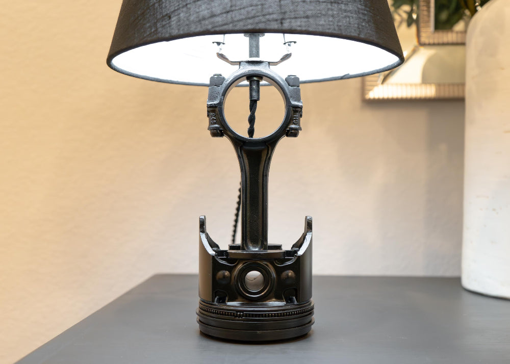 Table lamp made from mechanical components on a gray surface with a blurred background