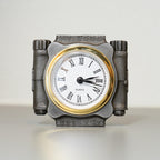 Decorative clock with metallic frame and white face on a light background