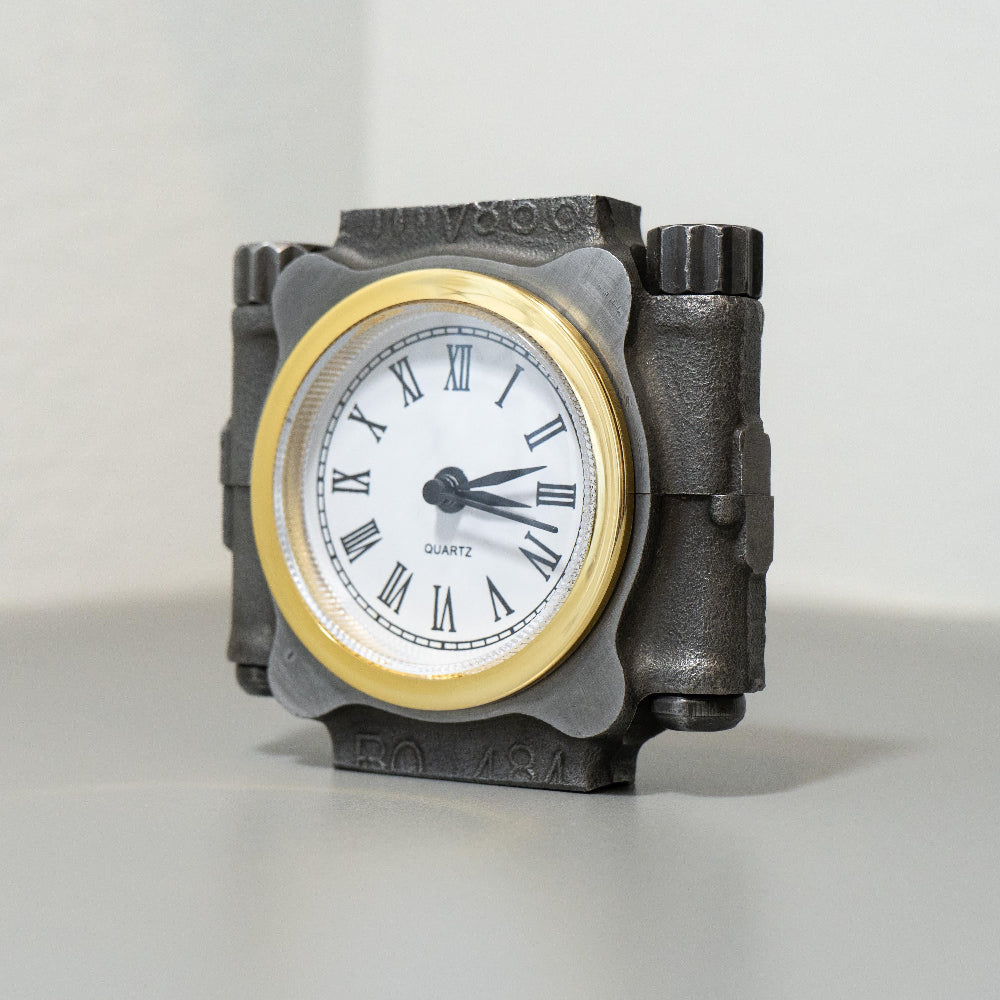 Decorative clock with a metallic casing on a light background