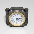 Mechanical-style clock with a gold rim and Roman numeral markers on a gray background