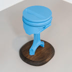 Blue object on a wooden base with a white background