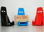 Three car seat racing harnesses in black, blue, and red with a business card holder in the center.