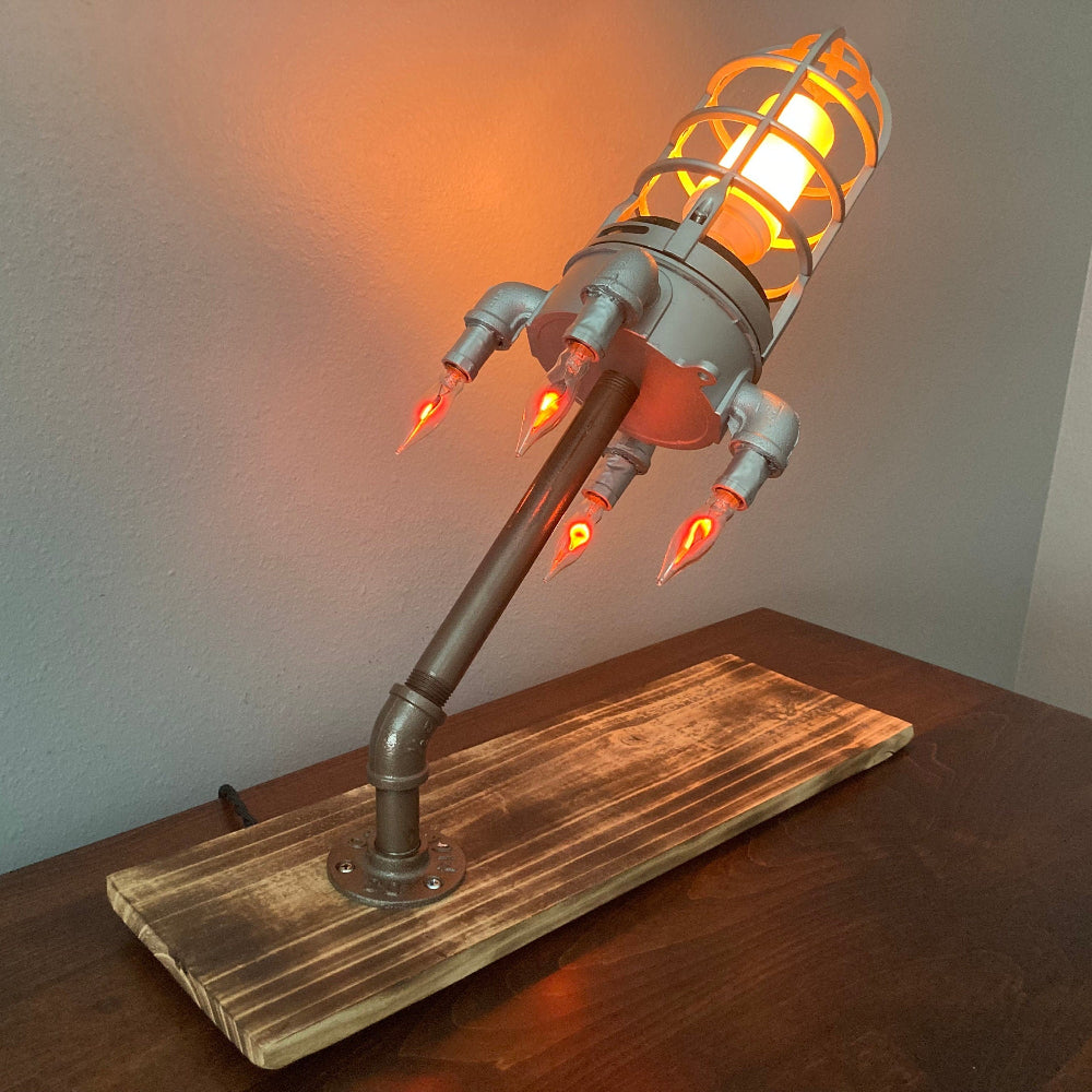 Steampunk-style lamp with glowing elements on a wooden base