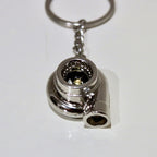 Metallic turbocharger keychain on a white background