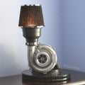 Turbocharger lamp on a wooden surface with a light blue gradient background