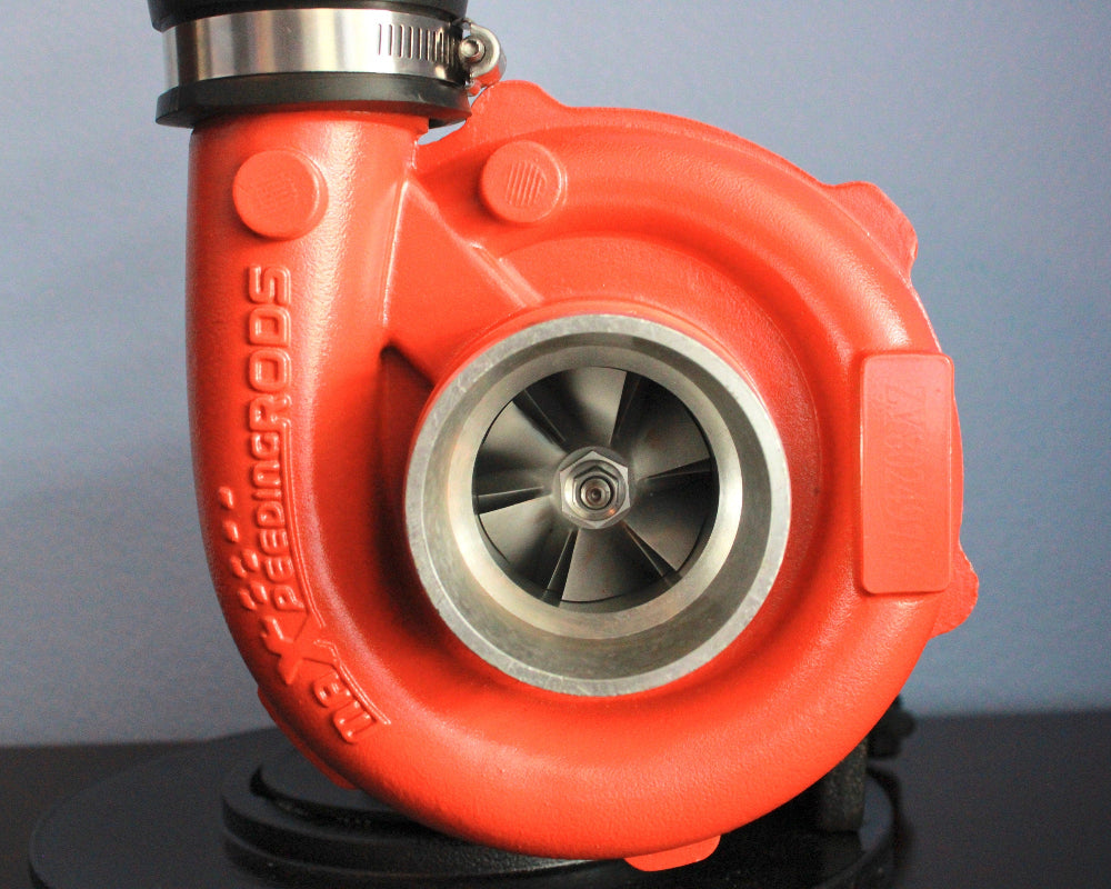 Red turbocharger on a black stand with a gray background
