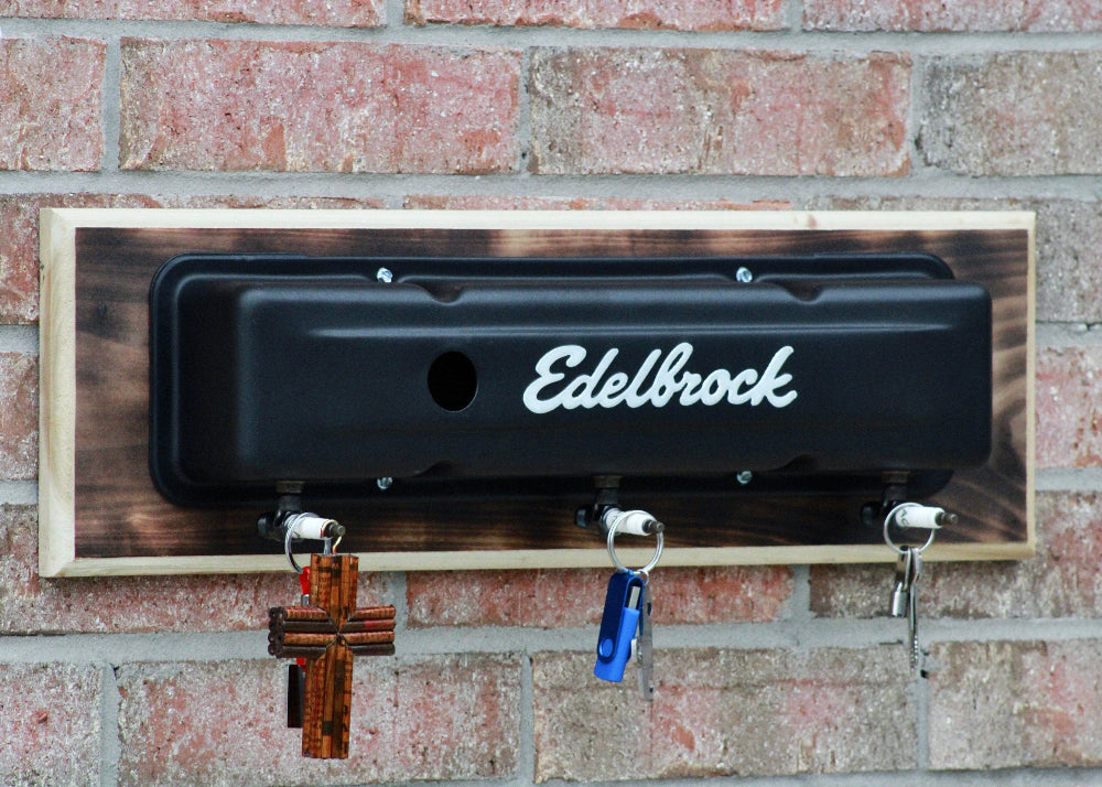 Edelbrock oil pan wall mount with hooks on a brick wall