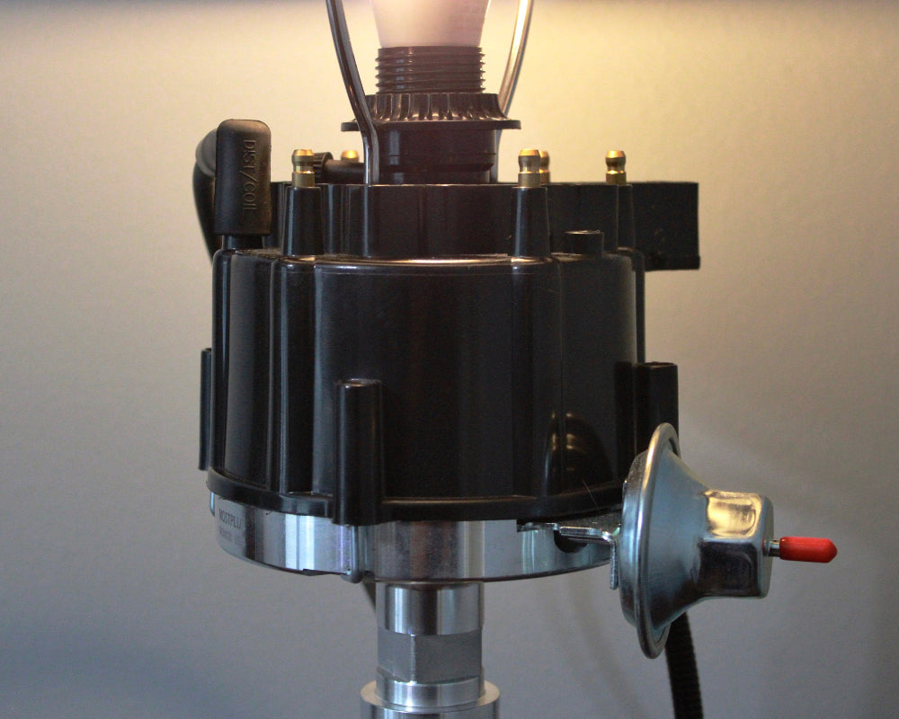 Lamp showcasing real engine details including distributor, rotor, and ignition wiring for authentic character.