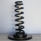 Sculptural automotive lamp that showcases the natural form of a real suspension spring.