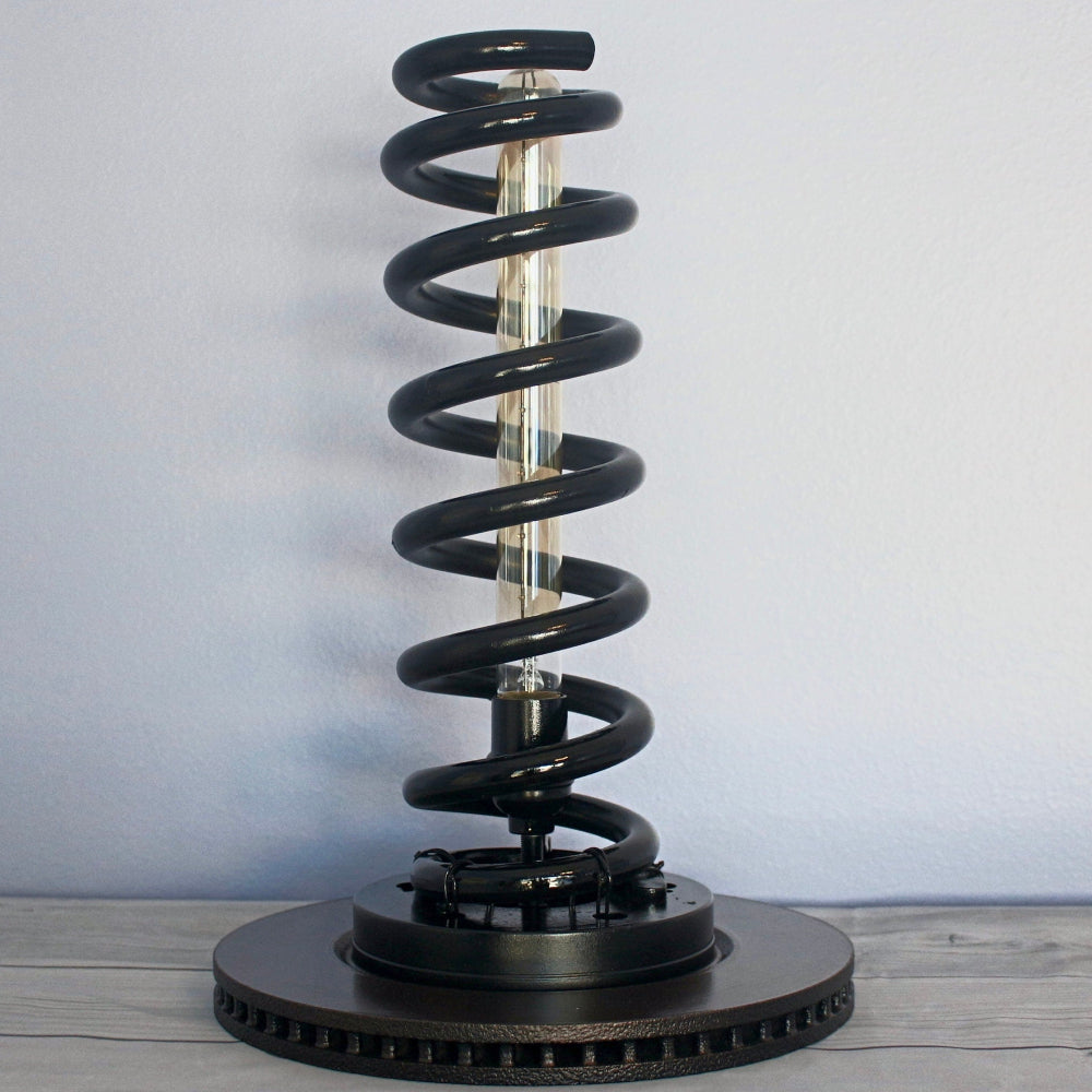 Sculptural automotive lamp that showcases the natural form of a real suspension spring.