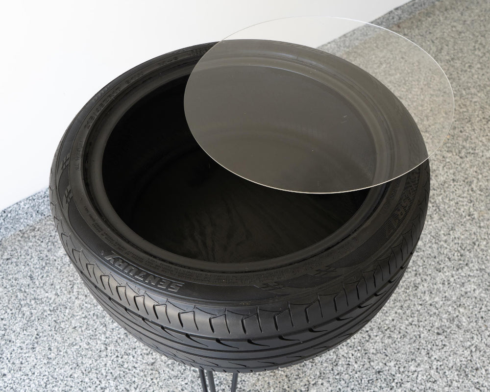 Stack of black tires on a concrete surface