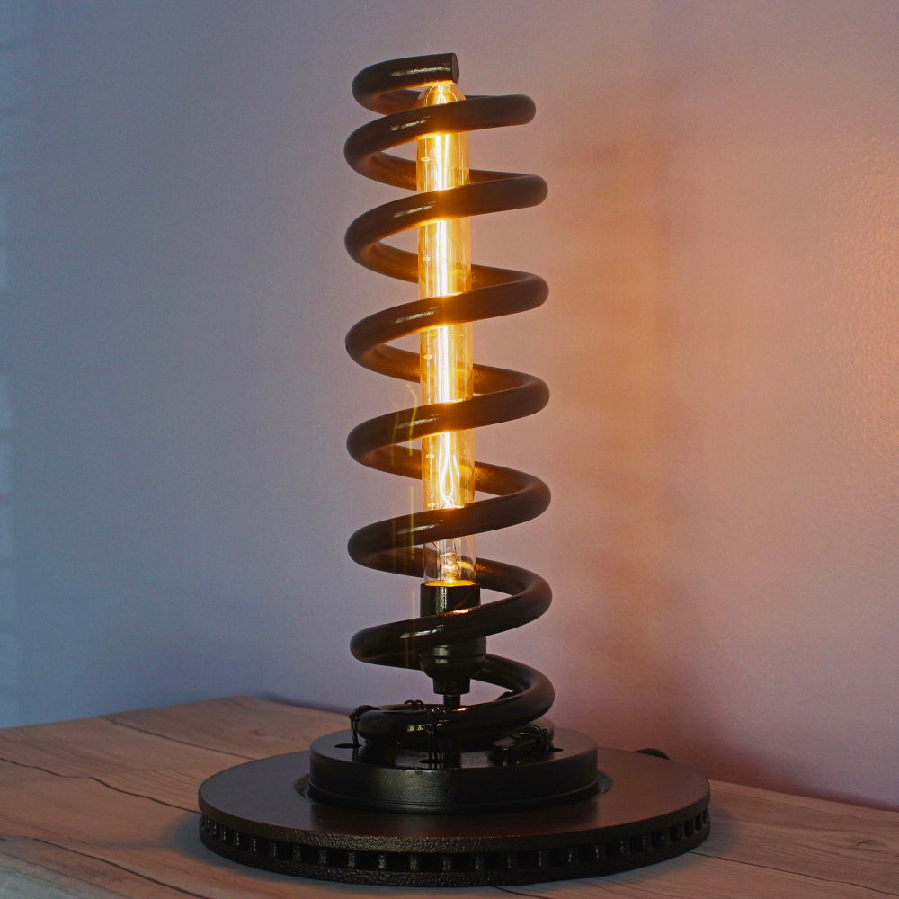 Car coil spring lamp handcrafted from an authentic suspension spring and mounted on a restored rotor base.